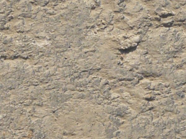 Road texture of asphalt covered in light beige dust and slightly rough, irregular surface.